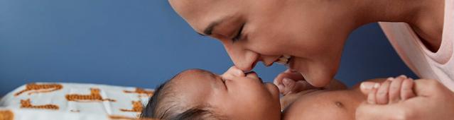 Mother rubbing nose on newborn's nose