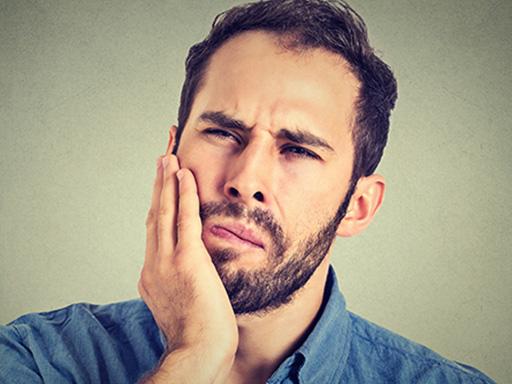 man looking concerned about tooth decay