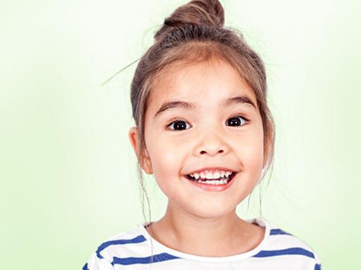 little girl with a striped shirt smiling