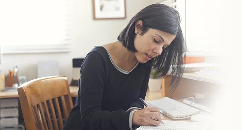 A woman writing in a notebook