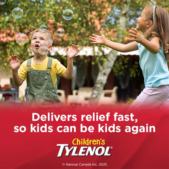 Two kids having fun catching soap bubbles