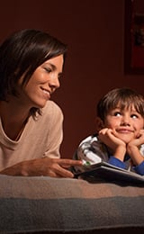 Mother and son bonding in bed during story time