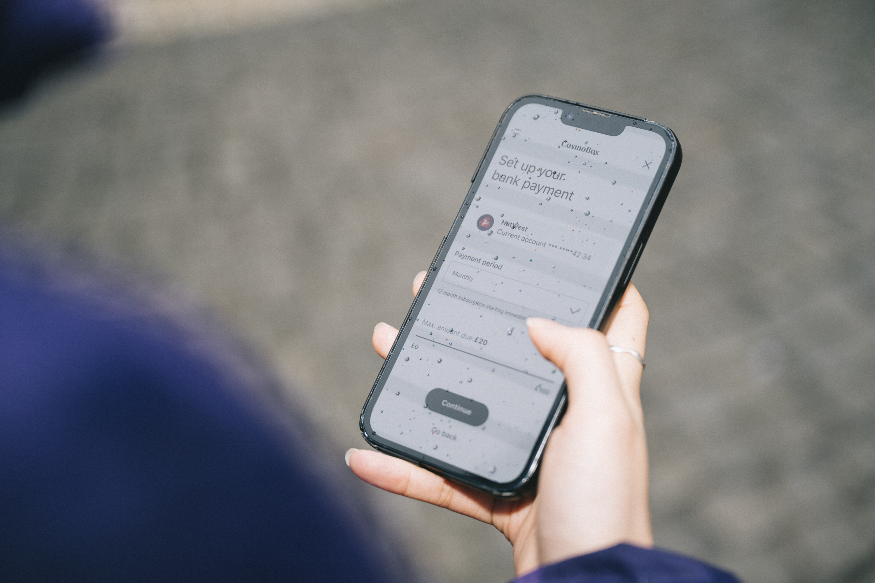 Person holding phone setting up bank