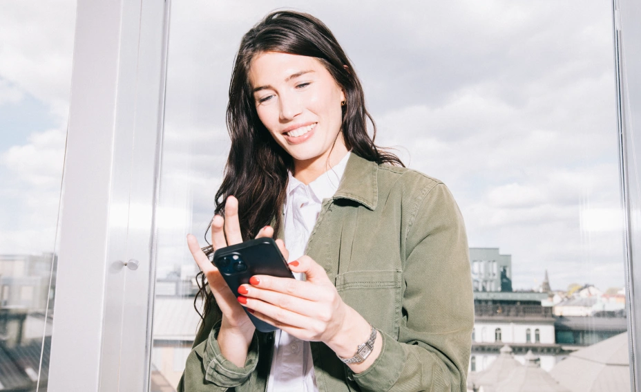 Dark haired woman looking at phone