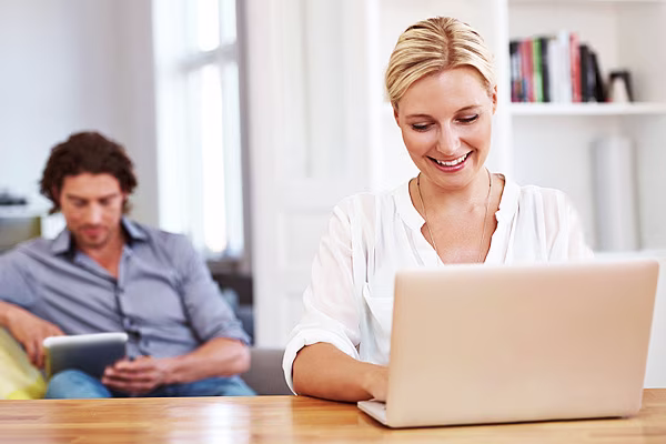 Man on iPad, woman using laptop