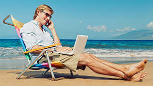 Man using phone at the beach