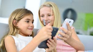 Kids using smartphones