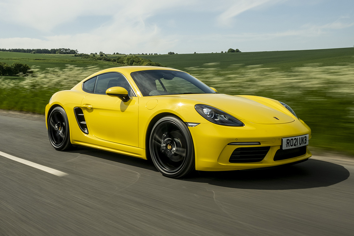 Porsche Cayman front driving yellow