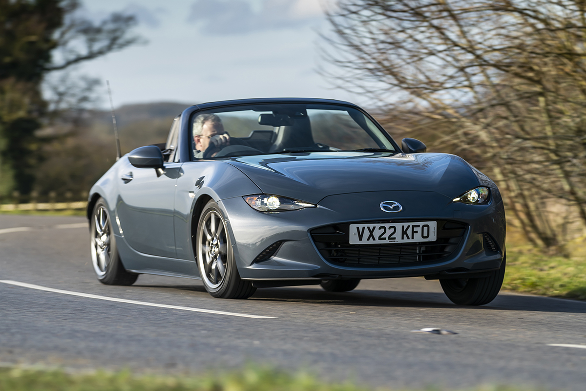 Mazda MX5 convertible front driving grey