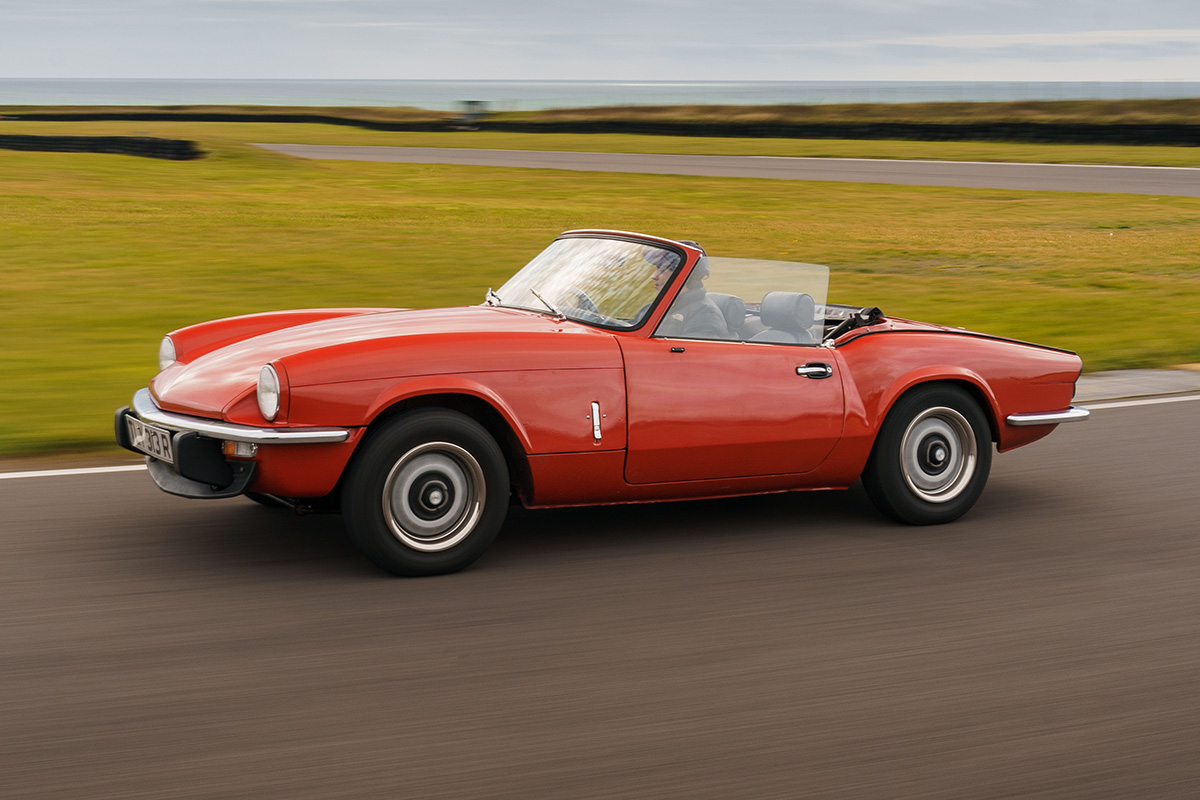 Triumph Spitfire side driving red