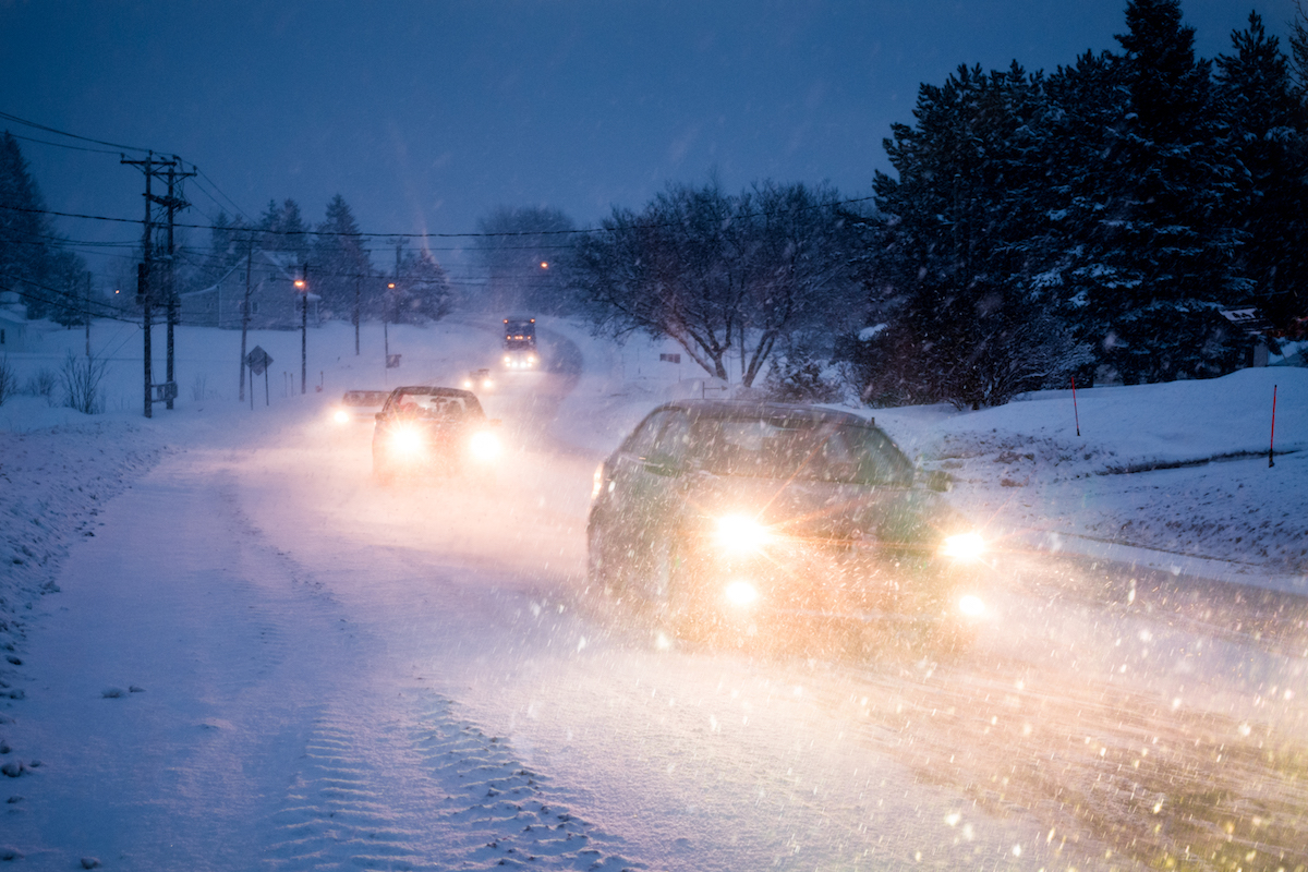 Cars driving in snow at night