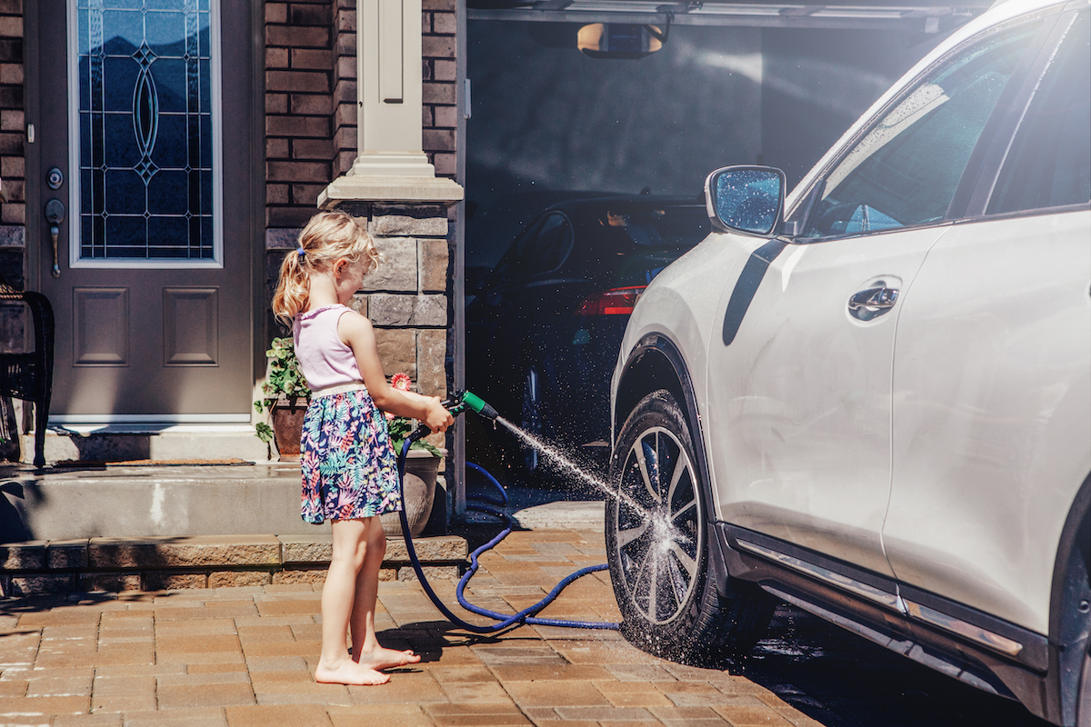 Car wash child spraying wheel