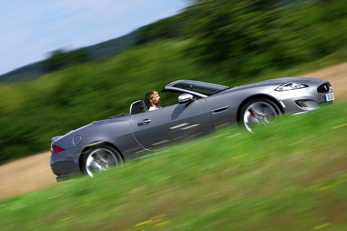 Jaguar XK side driving grey