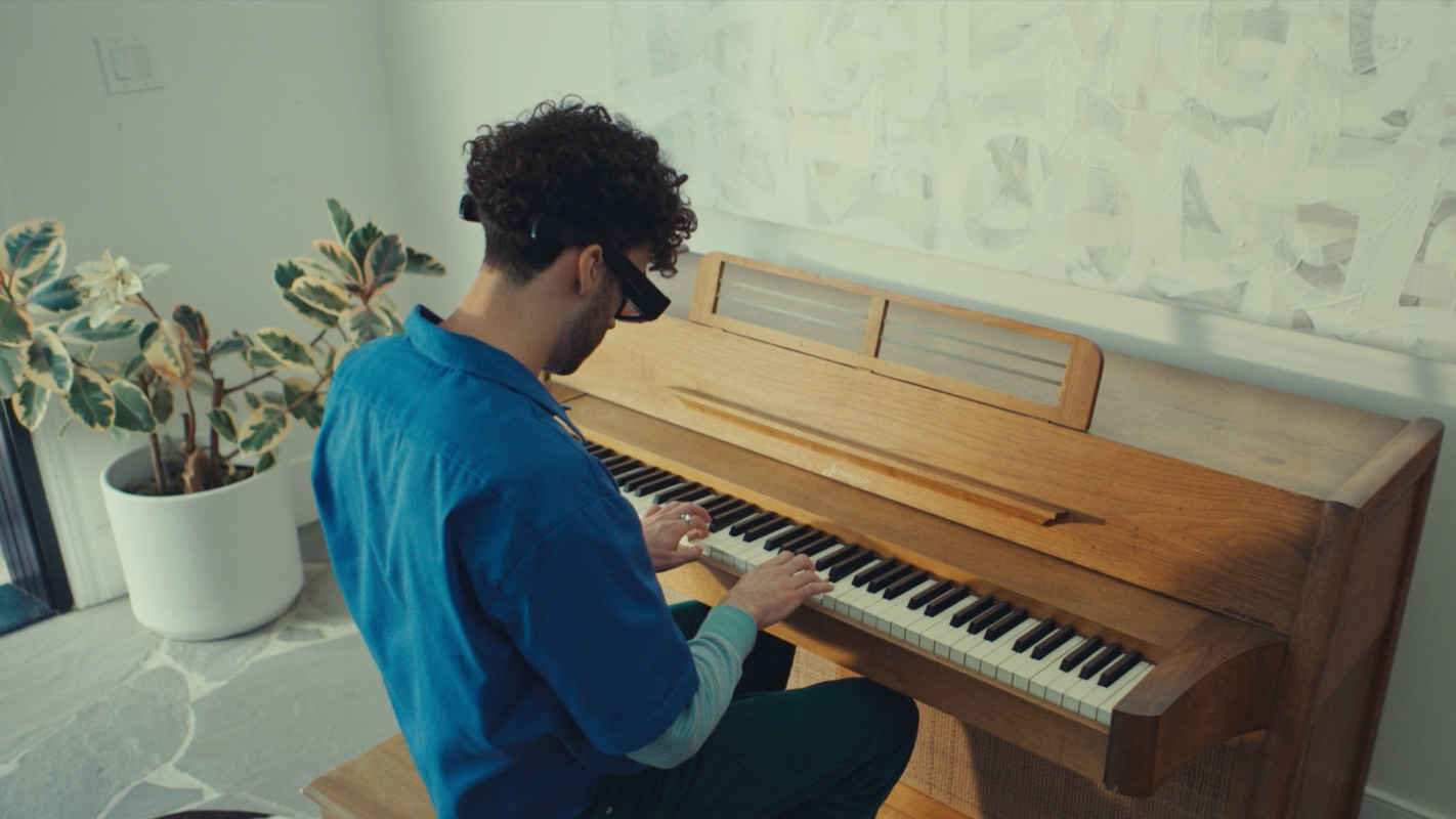 Image of person wearing Spectacles and playing Piano