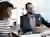 Image - two people discussing business on laptop