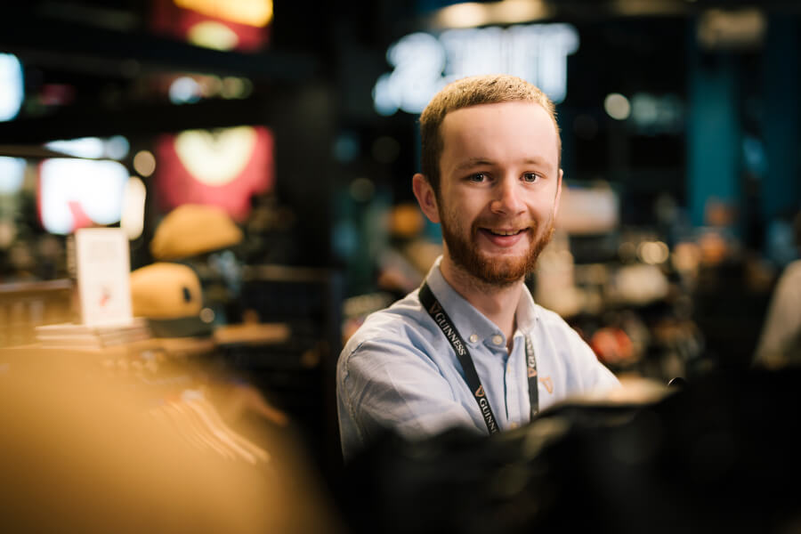 A happy man serving the perfect pint of Guinness at the in the Guinness Storehouse