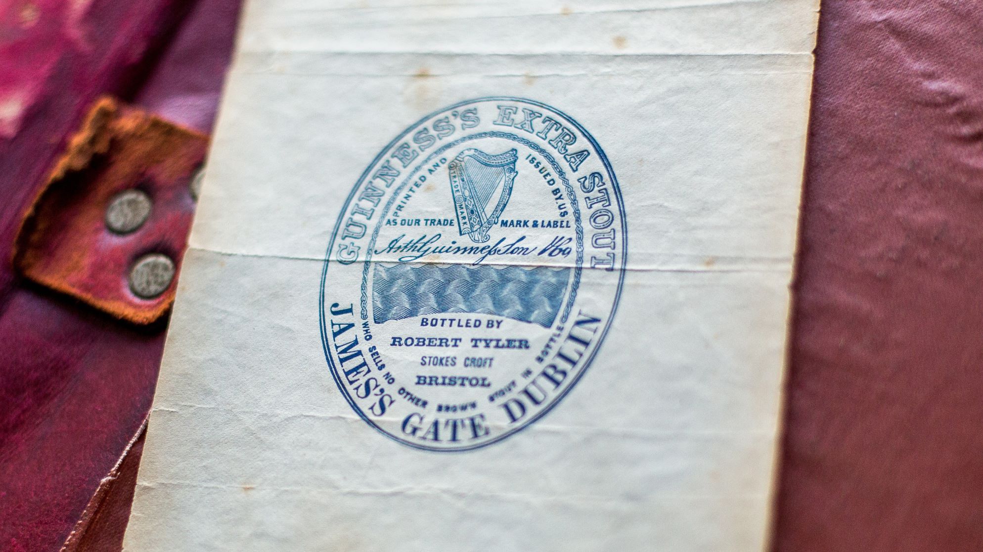 Original Guinness trademark label resting on a ledger.