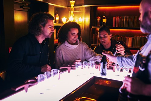 Tour guide showing the bottle's label to the visitors