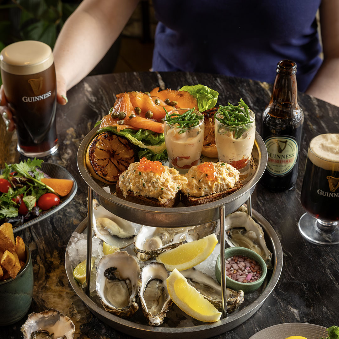 A photo of a friends enjoying an oyster tower in the Guinness Storehouse
