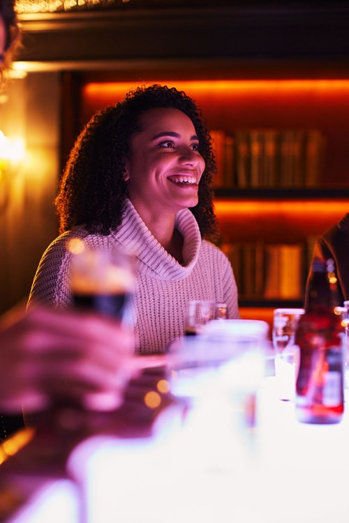 Smiley woman listening to the tour guide during her Connoisseur Experience