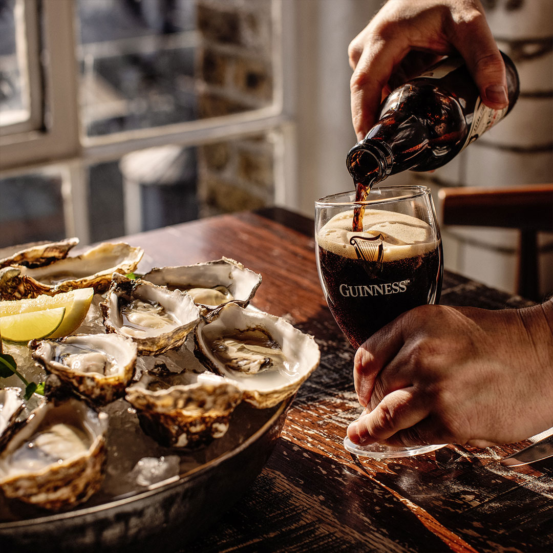 Guinness being poured alongside fresh oysters at the Guinness Storehouse