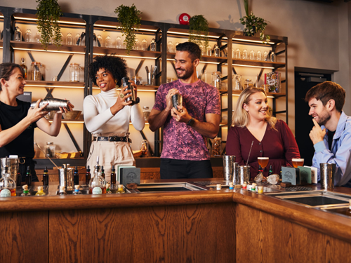 Group of friends taking a cocktail class at Roe & Co Distillery