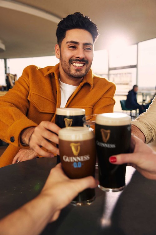 Friends enjoying pints of Guinness together