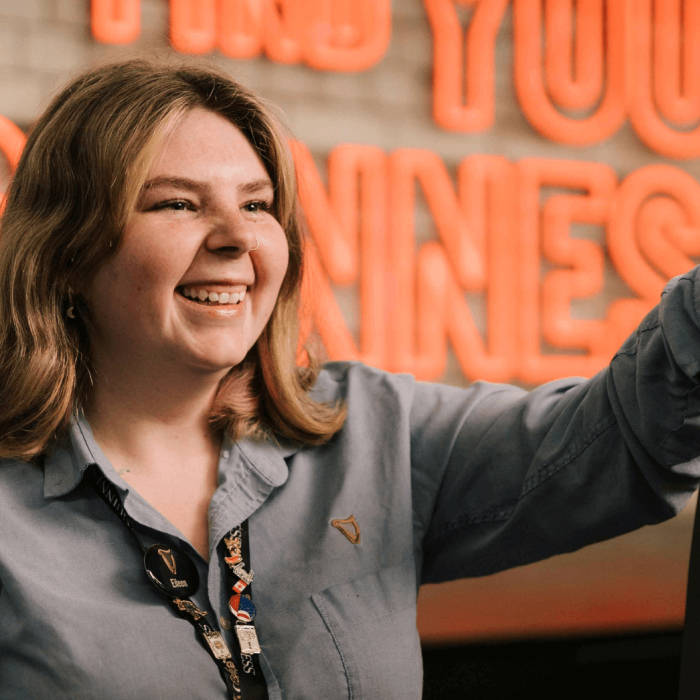 A smiling woman working in the Retail store at the Guinness Storehouse