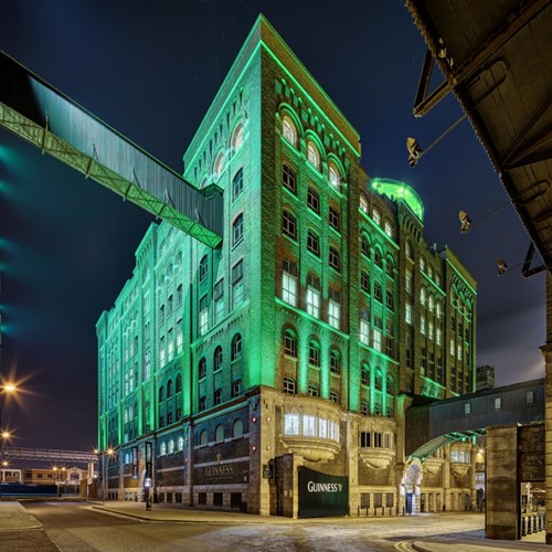 Outside view of the Guinness Storehouse building with green lighting