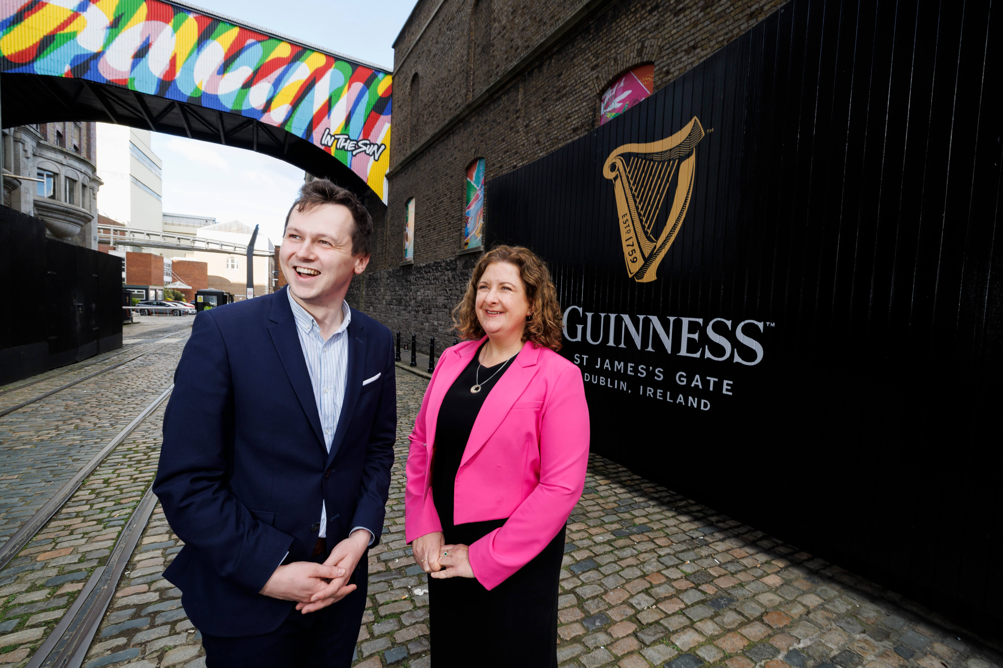 Man and woman standing in front of the Guinness Storehouse gate