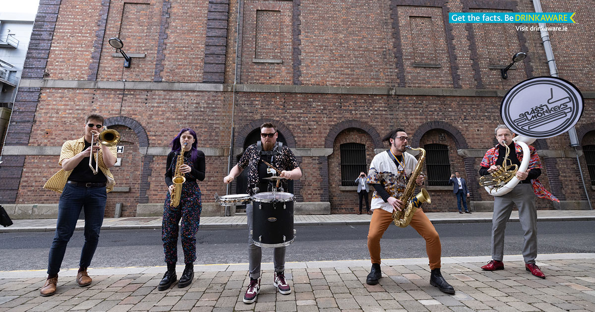 Band playing outside Guinness Storehouse, five musician each playing a different instrument