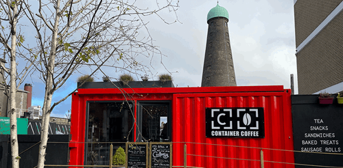 The exterior of Container Coffee in the Liberties, which is a red shipping container with a large glass door