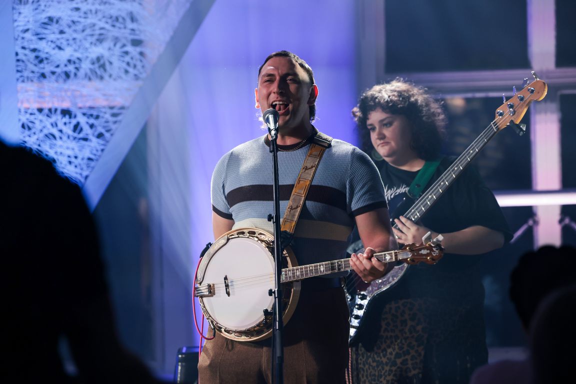 Singer performing with his band for a live music gig