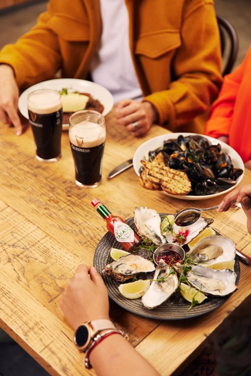 Seafood dishes paired with Guinness on a table