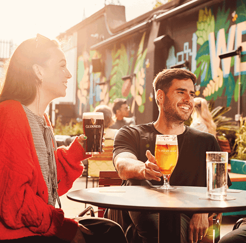 Friends enjoying pints together at Guinness Open Gate Brewery