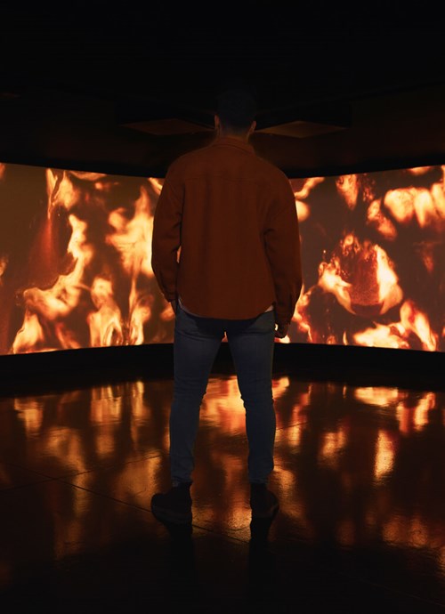 Man silhouette in front of large cinema screen