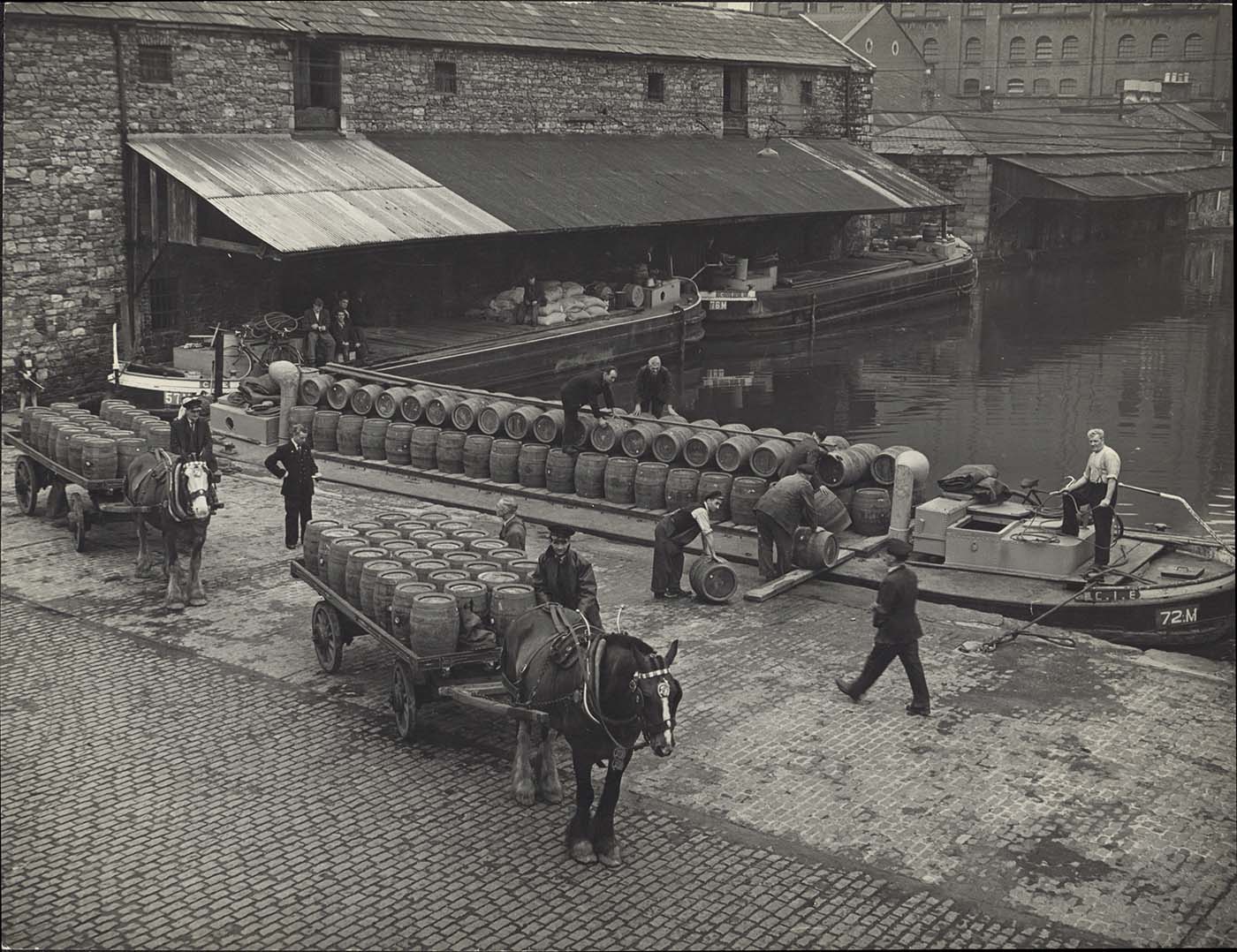 Black and white photograph of horses and drays at the Canal.