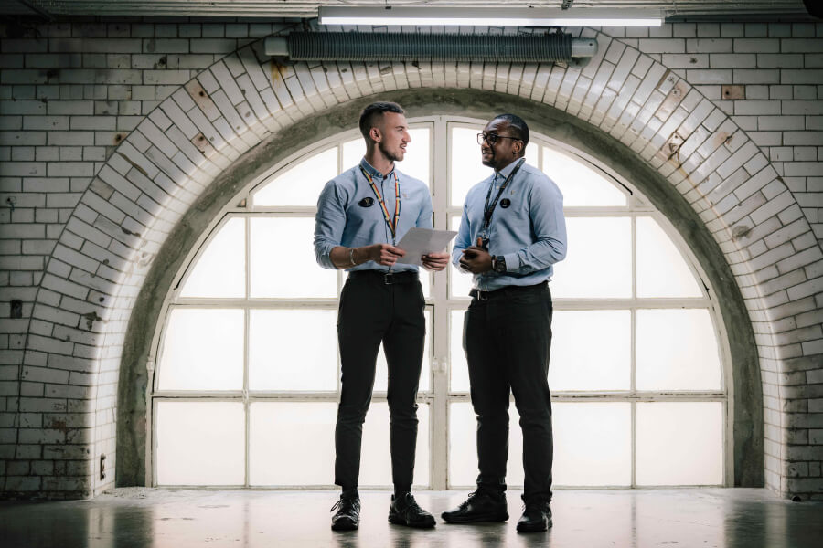 Two Guiness Storehouse employees talking with each other in the building