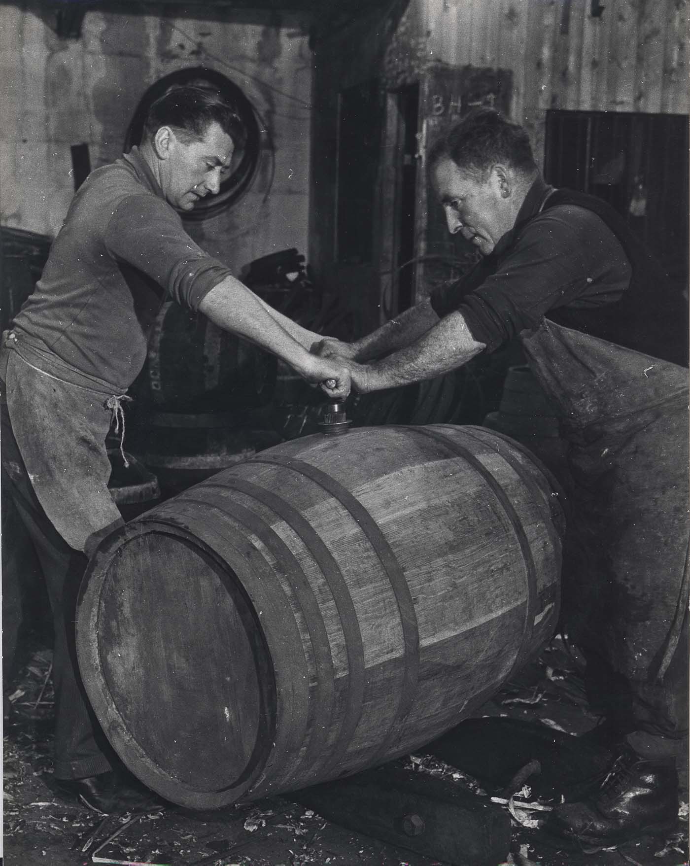 Two coopers working on a cask.