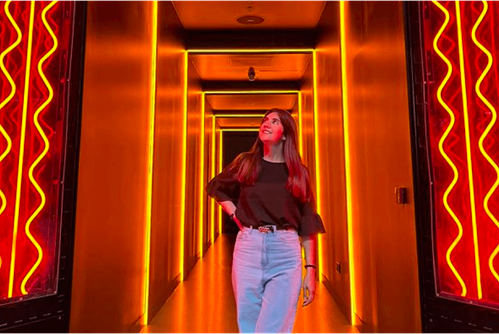 Happy woman standing in a corridor with lights