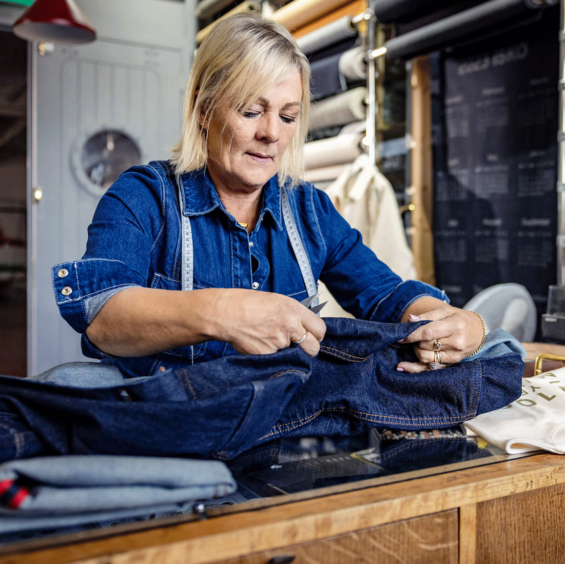 Seamstress working on a denim piece