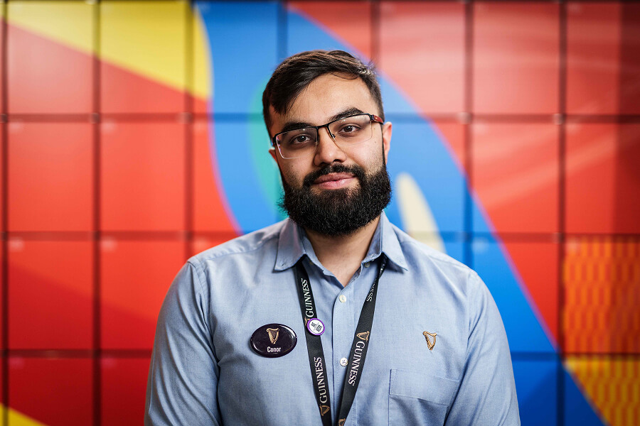 A Guinness Storehouse employee posing for a picture