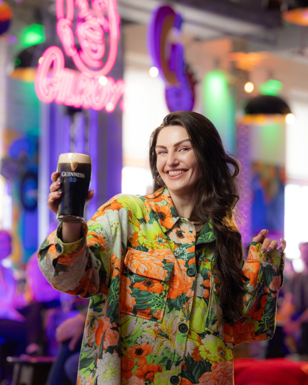 A Girl raising a toast of Guinness 0.0 in the Guinness Storehouse on St Patrick's Day