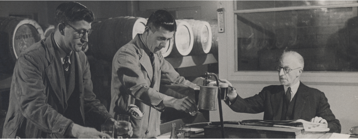 Bottling and quality scene at Guinness featuring three male members of staff. 