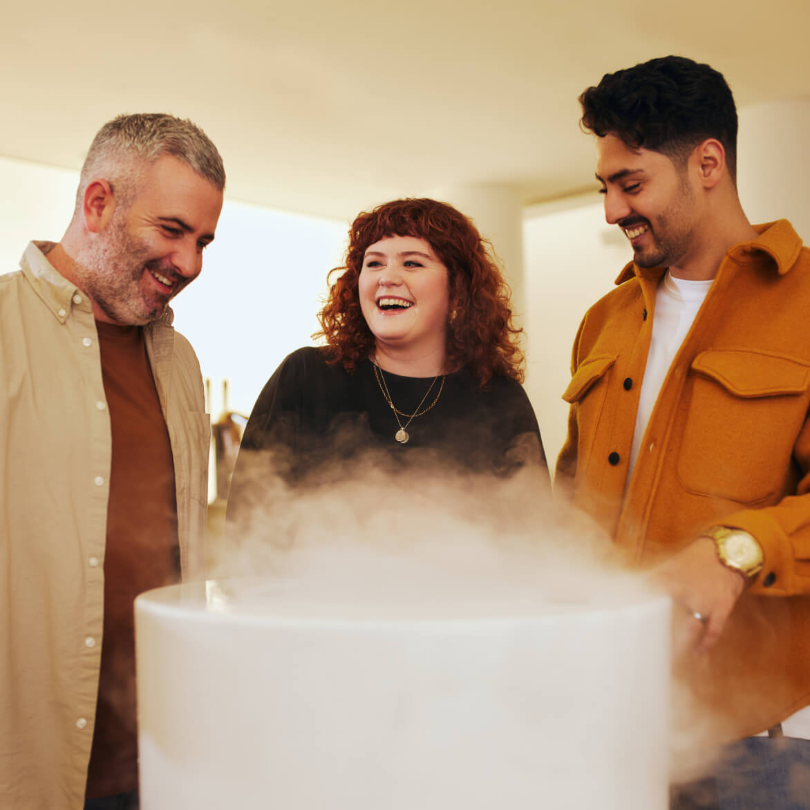 Three friends laughing and enjoying their experience in the Guinness Storehouse