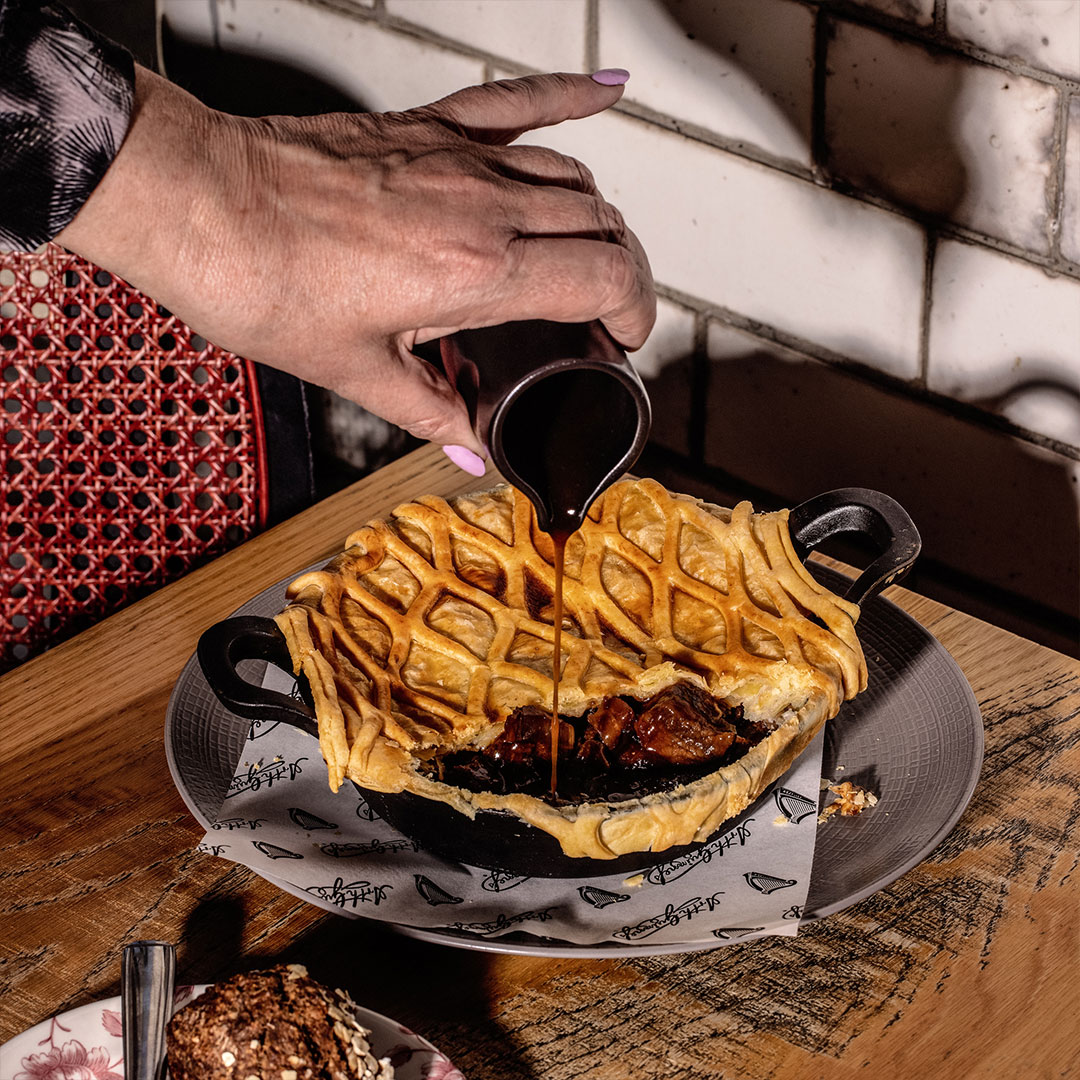 Pie with rich gravy being poured over it at the Guinness Storehouse