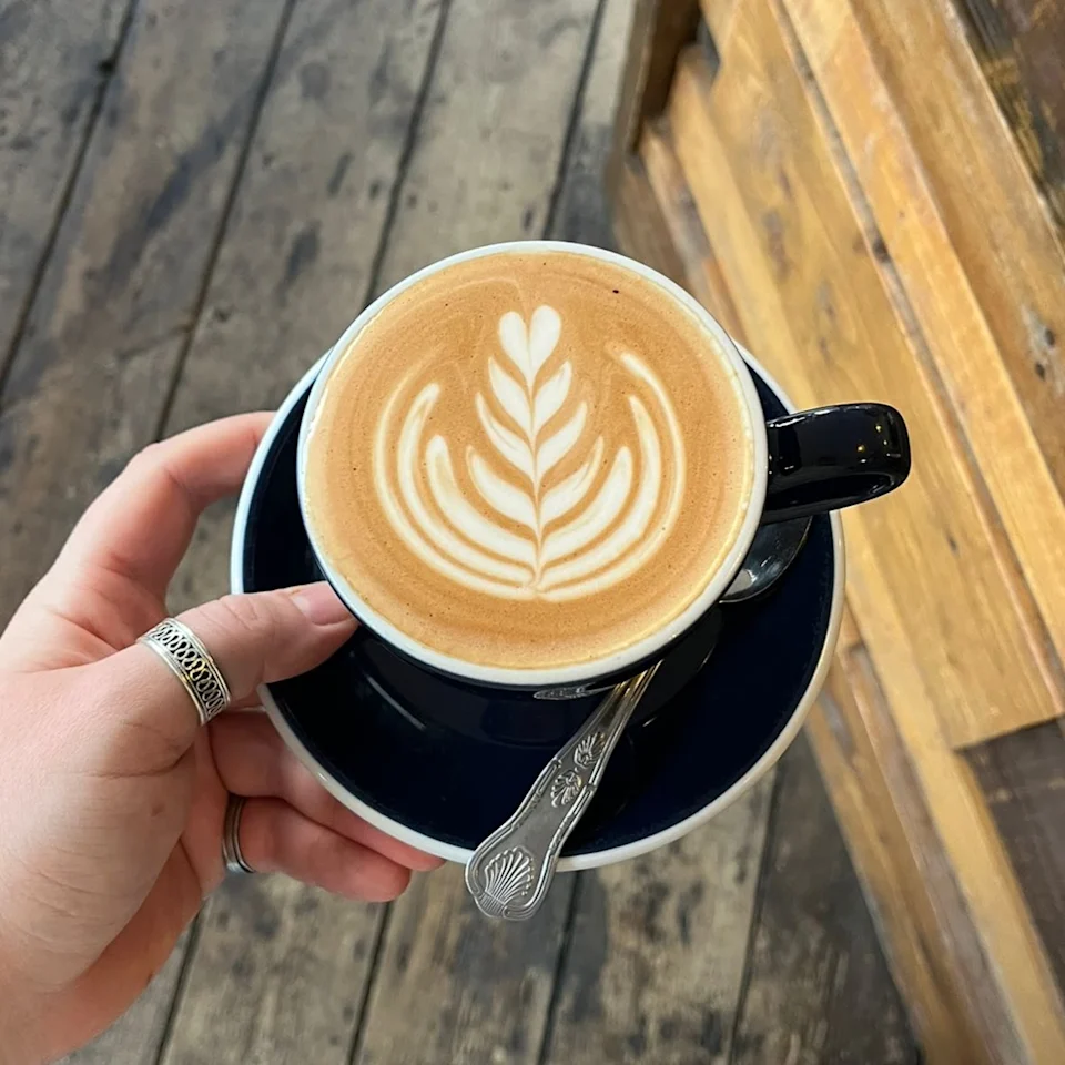 Blue coffee cups stacked on the espresso machine at Stage