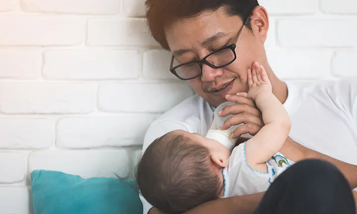 Dad feeding baby