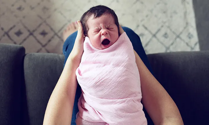 When to stop swaddling baby