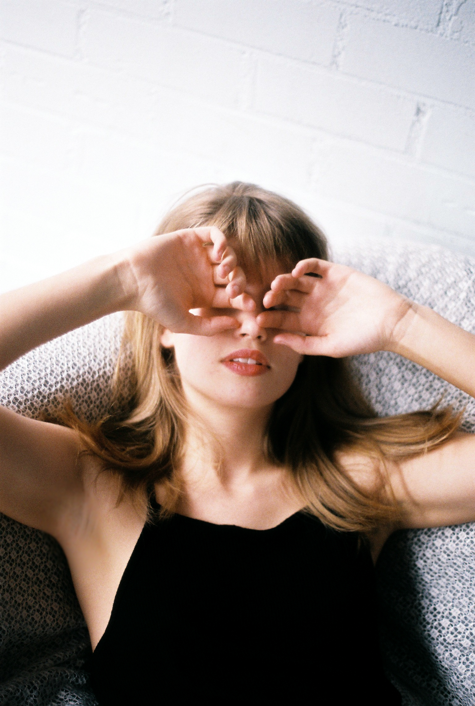 Girl with hands on eyes